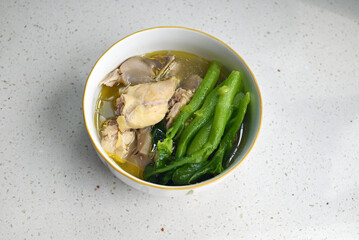 fresh stewd chicken meat with green vegetables in the bowl ready for eating
