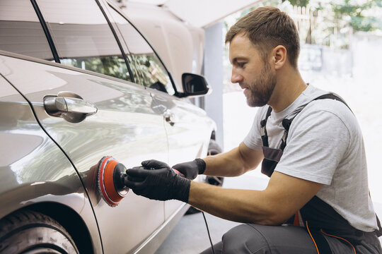 Professional Car Detailing with an Auto Polisher in a Garage Setting