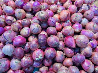 Vegetables zone in supermarket, pile of shallots, freshness red onion from garden