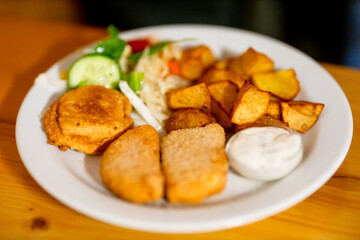 Czech dish of toasted cheese with tartar sauce and toppings.
