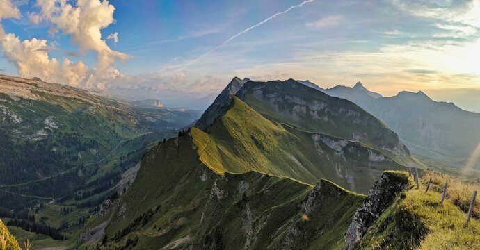 Sunset on a beautiful grass mountain in Switzerland. Evening atmosphere on the Lauiberg between the cantons of Glarus and Schwyz in the Swiss Alps with the beautiful Sihlseeli Unteriberg.