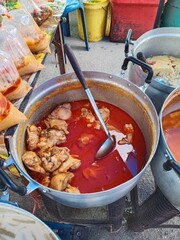 Chicken Massaman Curry in a stainless pot. Thai
street food. Curry and Rice Shop.