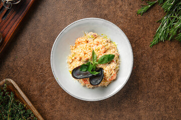 Portion of seafood risotto with mussel shells