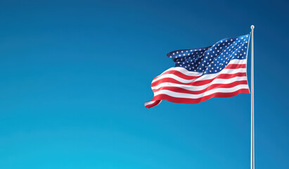 Fototapeta premium Waving American Flag Against Clear Blue Sky