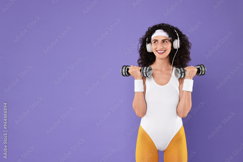 Poster Woman in headphones doing aerobic exercise with dumbbells on purple background, space for text