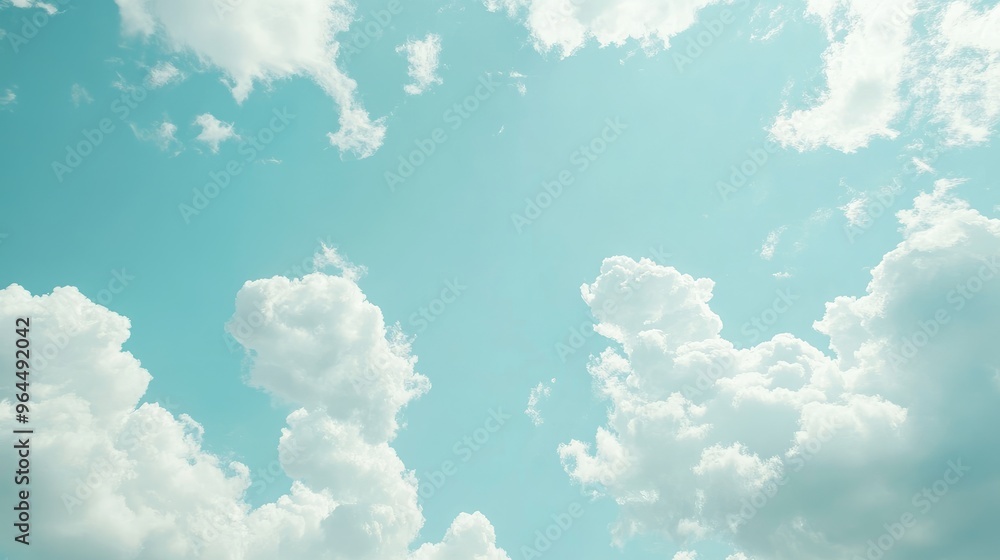 Poster vast light blue sky with bright white clouds, creating a tranquil background with open space for tex
