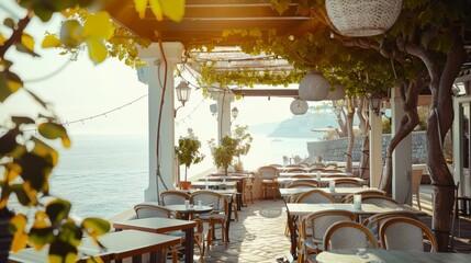 A charming seaside terrace with empty tables set under lush green vines, bathed in warm sunlight, ideal for a leisurely meal.