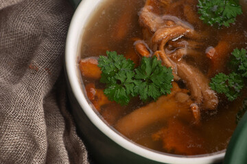 Soup with chanterelle mushrooms close up