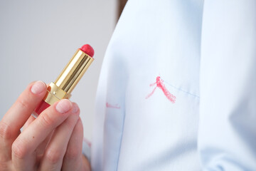 Dirty cosmetic lipstick stain on clothes. everyday life stain concept.