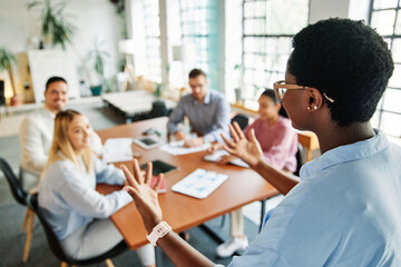 young business people meeting office teamwork group whiteboard presentation seminar latina woman businessman businesswoman startup project idea student education training