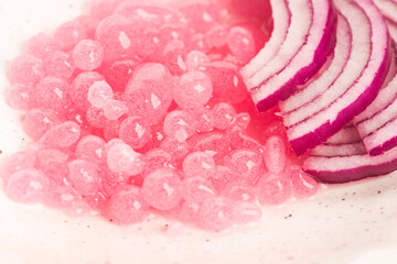 Molecular onion caviar balls on ceramics plate