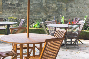 Empty wooden chairs and tables in restaurant outdoor