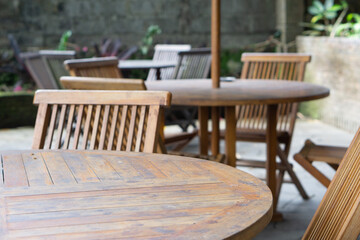 Empty wooden chairs and tables in restaurant outdoor