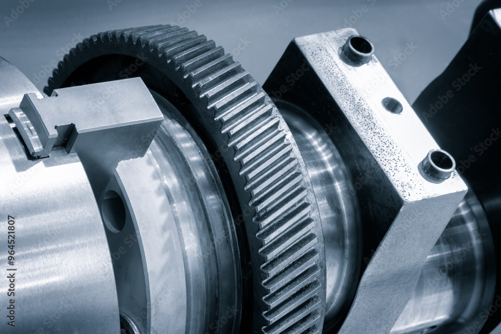 Poster a gear is being worked on with a tool. concept of precision and focus as the worker carefully manipu