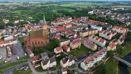 A view of Trzebiatów’s medieval center, featuring the towering red-brick Gothic church...