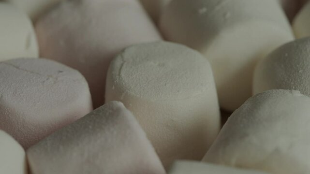 Marshmallows rotating macro. Sweet food. Unhealthy eating