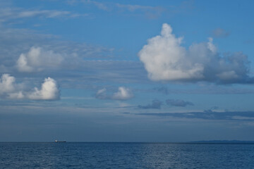Seascape with blue sky and white clouds over the sea. Beautiful seascape with clouds in the sky over the sea. Nature composition.