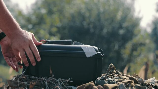 Male hands fold the drone and put it in a special protective case-bag. Close-up of hands folding a compact drone into a suitcase for storage.