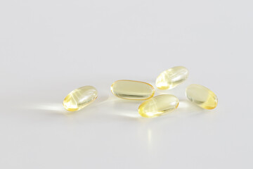 Soft Gel Capsules – Omega-3 Supplements on a white background. Healthy lifestyle. Minimalistic...