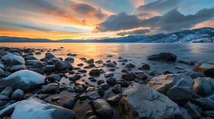 Photo of Lake Tahoe, boulders in the water at sunset, orange and blue sky, beautiful clouds, peaceful atmosphere, golden hour