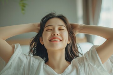 Fototapeta premium Portrait of beauty happy Asian woman awaking, wake up on the bed (sleep). Young beautiful Asian girl stretching her arms in fresh early morning, relax peaceful morning routine yawn concept banner