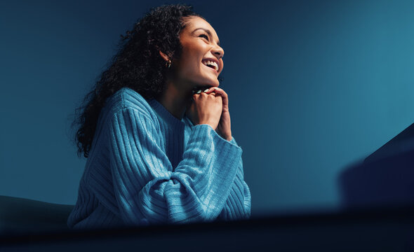 Businesswoman listening in a meeting, blue colorful studio shot