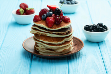 Stack of homemade american pancakes with berries . Top view