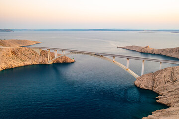 Pag Bridge with driving vehicles lasts over Adriatic sea channel. Vital infrastructure creates...