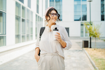 Young caucasian women student going to university at university campus	