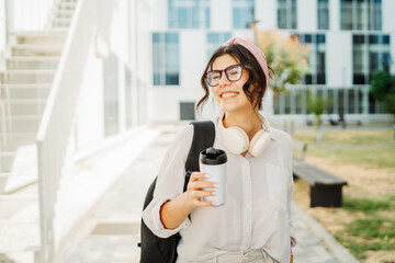 Fototapeta premium Young caucasian women student going to university at university campus 