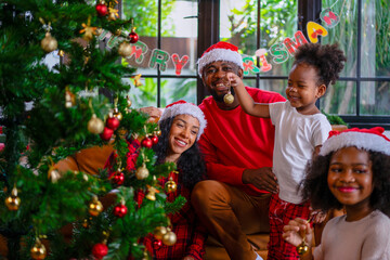 Family decorate Christmas tree at home.