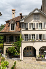 Typical building facade in downtown Bern Switzerland, with flowers in summer