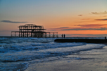 Remains of the West Pier on the beach of the English city of Brighton, while sunset 
