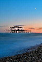 Remains of the West Pier on the beach of the English city of Brighton, while sunset 