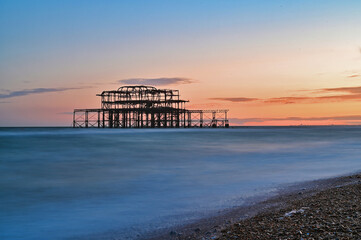 Remains of the West Pier on the beach of the English city of Brighton, while sunset 