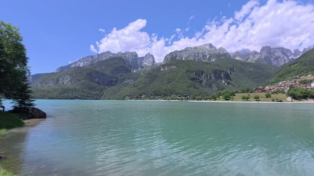 The town and lake of Molveno at the foot of the Brenta Dolomites in Trentino, Italy on a beautiful summer day