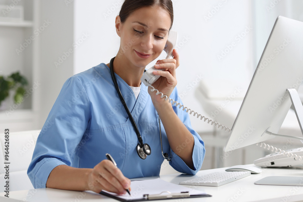 Poster Nurse consulting patient by phone at white table in clinic