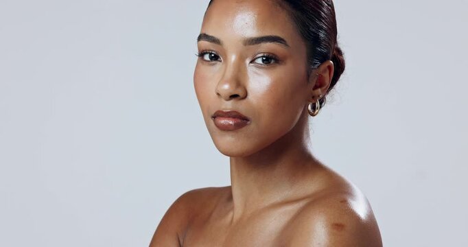Elegant, face or model in studio with makeup, glow or wellness on white background for shine or health. Classy woman, proud and serious girl with confidence, cosmetics and beauty skincare results