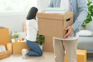 People relocation move home concept, Man carrying belongings box moving in new apartment.