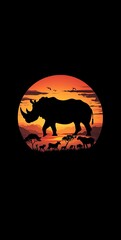 Fototapeta premium Silhouette of a rhinoceros at sunset in an African savanna with wildlife