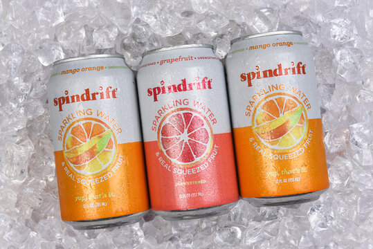 IRVINE, CALIFORNIA - 6 SEPT 2024: three cans of Spindrift Sparkling Water on a bed of ice, Mango Orange, and Grapefruit flavored.