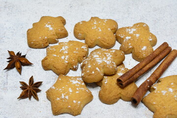 a pile of gingerbread cookies with some cinnamon sticks on the top