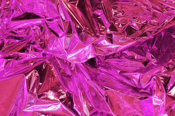 Crumpled pink foil. Abstract background or texture.