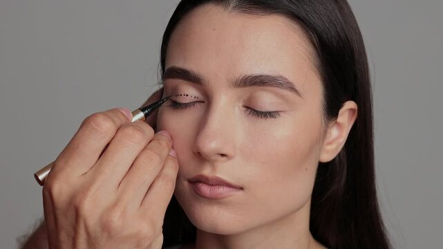 Surgeon is planning process of upper blepharoplasty with marker 4k video. Surgeon is drawing marking lines on eyelid of patient to have accurate operation.