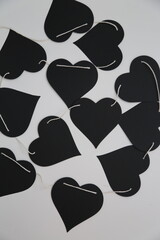 Black paper hearts garland is romantic decoration for Saint Valentine day.