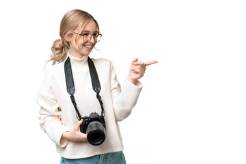 Young photographer English woman over isolated background pointing finger to the side and...