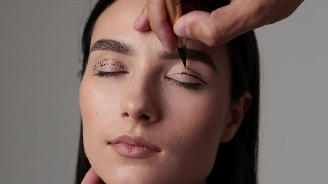 Blepharoplasty markup close-up on the face before the plastic surgery operation for modifying the eye region of the face in medical clinic 4k video.