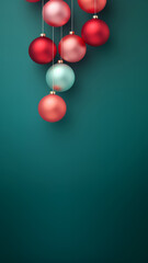 Christmas red and green matte ornaments on teal green background with copy space