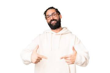 Young man with beard over isolated chroma key background proud and self-satisfied