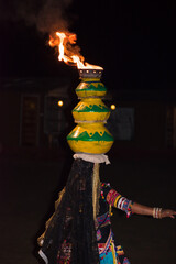 Traditional Folk Dance of Rajasthan. An artist performing dance by putting fire matka or pot on her head